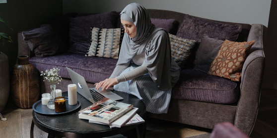 Woman in Gray Hijab Sitting on Couch